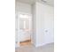En-suite bathroom featuring a white vanity and wood-look flooring, accessible from the carpeted bedroom at 266 Fast Pitch Ln, Four Oaks, NC 27524