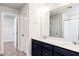 Bathroom featuring a double sink vanity with dark blue cabinets and a walk-in closet in view at 266 Fast Pitch Ln, Four Oaks, NC 27524