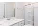 Clean, well-lit bathroom featuring a shower with glass door and a vanity with a white countertop at 266 Fast Pitch Ln, Four Oaks, NC 27524