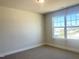 Bedroom with neutral walls, carpet flooring, natural light filled with a large window at 266 Fast Pitch Ln, Four Oaks, NC 27524