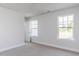 Bright bedroom featuring two windows and neutral carpet at 266 Fast Pitch Ln, Four Oaks, NC 27524