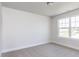 Bright bedroom with neutral carpet and a large window at 266 Fast Pitch Ln, Four Oaks, NC 27524
