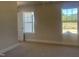 Bedroom featuring neutral walls, carpet flooring, and natural light from dual windows at 266 Fast Pitch Ln, Four Oaks, NC 27524