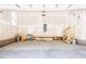 Spacious garage with concrete floor, window, and stairs leading to an upper level or storage area at 266 Fast Pitch Ln, Four Oaks, NC 27524