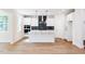 Modern kitchen with stainless steel appliances, island, and dark backsplash at 266 Fast Pitch Ln, Four Oaks, NC 27524