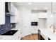 Bright kitchen showcasing modern appliances, stylish backsplash, white cabinets and hardware at 266 Fast Pitch Ln, Four Oaks, NC 27524
