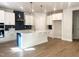 Bright kitchen featuring white cabinets, a large island with quartz countertops, and modern stainless steel appliances at 266 Fast Pitch Ln, Four Oaks, NC 27524