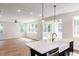 Open-concept area with hardwood floors and a view of the outdoor scenery at 266 Fast Pitch Ln, Four Oaks, NC 27524