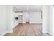 Open-concept living space featuring wood floors and modern white kitchen in a well-lit environment at 266 Fast Pitch Ln, Four Oaks, NC 27524