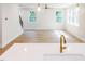 Open floor plan showcasing a modern kitchen and living area with hardwood floors at 266 Fast Pitch Ln, Four Oaks, NC 27524