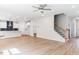 Spacious open-concept featuring a staircase, kitchen, and hardwood floors at 266 Fast Pitch Ln, Four Oaks, NC 27524
