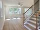 An open-concept living room showcases abundant natural light from multiple windows and hardwood style floors at 266 Fast Pitch Ln, Four Oaks, NC 27524