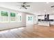 Spacious living room and kitchen area with lots of natural light and hardwood floors at 266 Fast Pitch Ln, Four Oaks, NC 27524