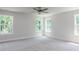 A bright main bedroom features three windows bringing in natural light and neutral carpeting at 266 Fast Pitch Ln, Four Oaks, NC 27524