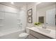 Bright bathroom featuring a shower and tub combo, framed mirror, and neutral countertop with a sink at 52 Macy Cir, Wendell, NC 27591
