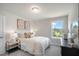 Cozy bedroom with plush carpet, a window with a view, and decoratively adorned with pillows and wall art at 52 Macy Cir, Wendell, NC 27591