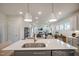Open-concept kitchen with island seating, stainless steel appliances, and a view of the living area at 52 Macy Cir, Wendell, NC 27591