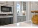 Elegant kitchen with built-in microwave and oven, bright counter tops and pendant lighting at 52 Macy Cir, Wendell, NC 27591