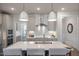 Open kitchen with island, stainless steel range hood, and white cabinets at 52 Macy Cir, Wendell, NC 27591