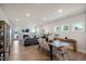 Open-concept living and dining area with fireplace and ample natural light at 52 Macy Cir, Wendell, NC 27591