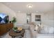 Bright living room featuring a large sectional sofa, modern decor, plush carpet, and mounted TV at 52 Macy Cir, Wendell, NC 27591