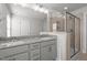 Bathroom with double vanity, grey cabinets, granite counters, and glass shower at 951 Alma Railway Dr # 561, Wake Forest, NC 27587