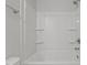 Bright white shower and tub combination with built in shelving at 951 Alma Railway Dr # 561, Wake Forest, NC 27587