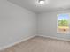 A simple bedroom with neutral walls, carpet, and natural light at 951 Alma Railway Dr # 561, Wake Forest, NC 27587