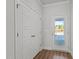 Bright entryway with hardwood floors, a closet, and a glass door leading outside at 951 Alma Railway Dr # 561, Wake Forest, NC 27587