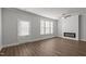 Bright living room featuring hardwood floors, a fireplace, a ceiling fan, and natural light at 951 Alma Railway Dr # 561, Wake Forest, NC 27587