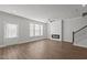 Open living area with fireplace, wood floors, ceiling fan, and staircase at 951 Alma Railway Dr # 561, Wake Forest, NC 27587