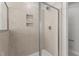 A shower with light tiled walls and a glass surround at 951 Alma Railway Dr # 561, Wake Forest, NC 27587