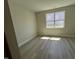 Bright and airy bedroom with modern vinyl flooring and a large window at 96 Little Creek Dr, Lillington, NC 27546