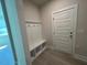 Mudroom entryway with convenient storage bench and coat hooks at 96 Little Creek Dr, Lillington, NC 27546