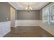 Formal dining room with elegant wainscoting, chandelier, and natural light at 98 Valley Brook Ln, Spring Lake, NC 28390