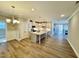 Spacious open-concept kitchen featuring an island, stainless appliances, pendant lighting, and hardwood floors at 1044 Fairhaven Dr # 100, Mebane, NC 27302