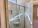 Modern bathroom featuring tiled shower with glass door and built-in seat at 1044 Fairhaven Dr # 100, Mebane, NC 27302