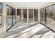 Bright sunroom with wall-to-wall windows and tiled floors at 12905 Barsanlaw Dr, Raleigh, NC 27613