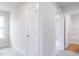 Hallway with multiple doorways and a glimpse of a bathroom with a shower and tub combo at 281 Little Creek Dr, Lillington, NC 27546