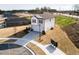 Aerial view of a modern two-story home featuring a two-car garage and well-manicured lawns at 305 Little Creek Dr, Lillington, NC 27546