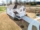 Spacious two-story house with a large driveway and expansive front yard on a sunny day at 305 Little Creek Dr, Lillington, NC 27546