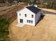 Exterior aerial of a modern two-story house showcasing the backyard with fresh landscaping at 305 Little Creek Dr, Lillington, NC 27546