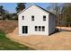 Rear exterior view of a two-story house surrounded by newly installed landscaping at 305 Little Creek Dr, Lillington, NC 27546