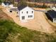 Back aerial view of new two-story home with patio, surrounded by newly seeded grass at 305 Little Creek Dr, Lillington, NC 27546