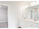 Bright bathroom featuring a double sink vanity with white cabinets and a spacious walk-in closet at 305 Little Creek Dr, Lillington, NC 27546