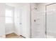 Bright bathroom featuring a glass shower and window with natural light at 305 Little Creek Dr, Lillington, NC 27546