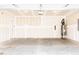 Spacious unfinished two car garage with concrete flooring and a water heater at 305 Little Creek Dr, Lillington, NC 27546