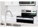 Bright kitchen featuring stainless steel appliances and white cabinets at 305 Little Creek Dr, Lillington, NC 27546