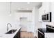 Modern kitchen features white cabinetry and island with pendant lighting at 305 Little Creek Dr, Lillington, NC 27546