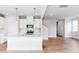 Modern kitchen features white cabinetry and island with pendant lighting at 305 Little Creek Dr, Lillington, NC 27546